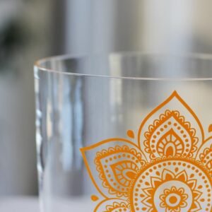 clear crystal singing bowl with sacral chakra design