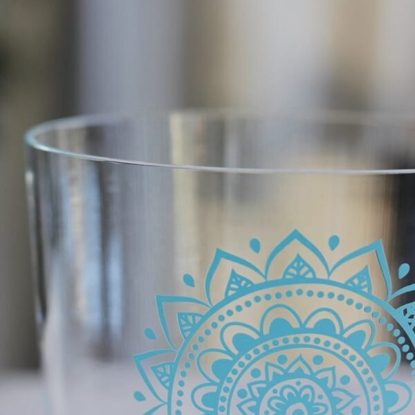 clear crystal singing bowl with throat chakra design